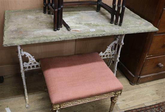 A Victorian cast iron table with a stone top W.112cm